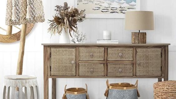 rattan sideboard with lamp and dried flowers